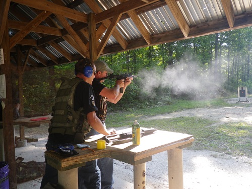 Chapter 54 member firing SMG during Foreign Weapons familiarization course